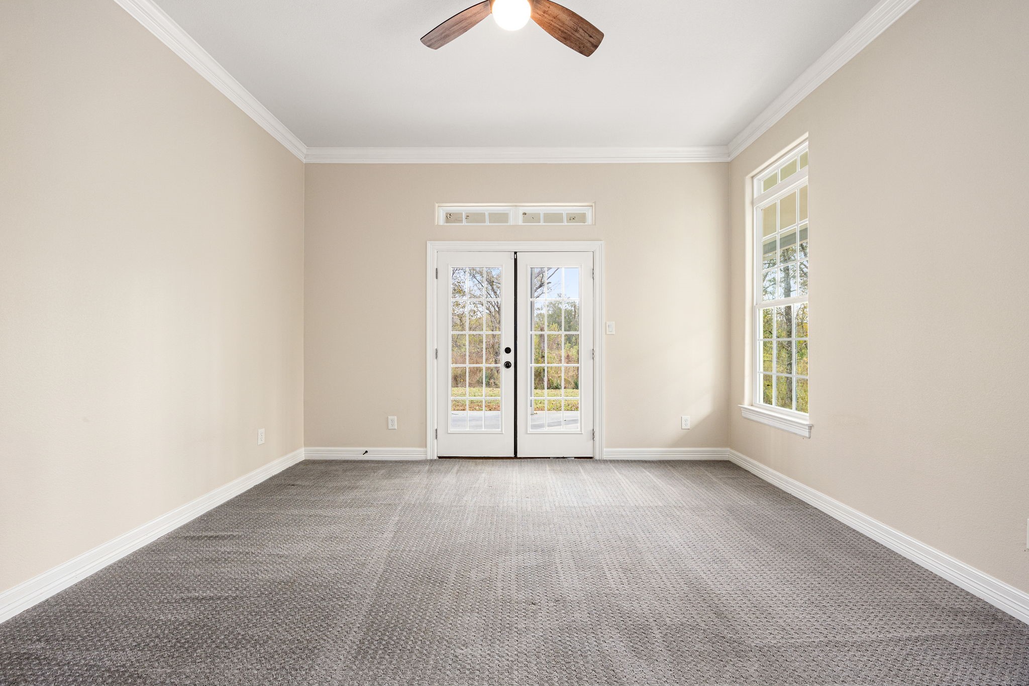14882 Gingham Road Montgomery, TX 77356 - Photo 28 of 50 an empty room with chandelier fan and windows