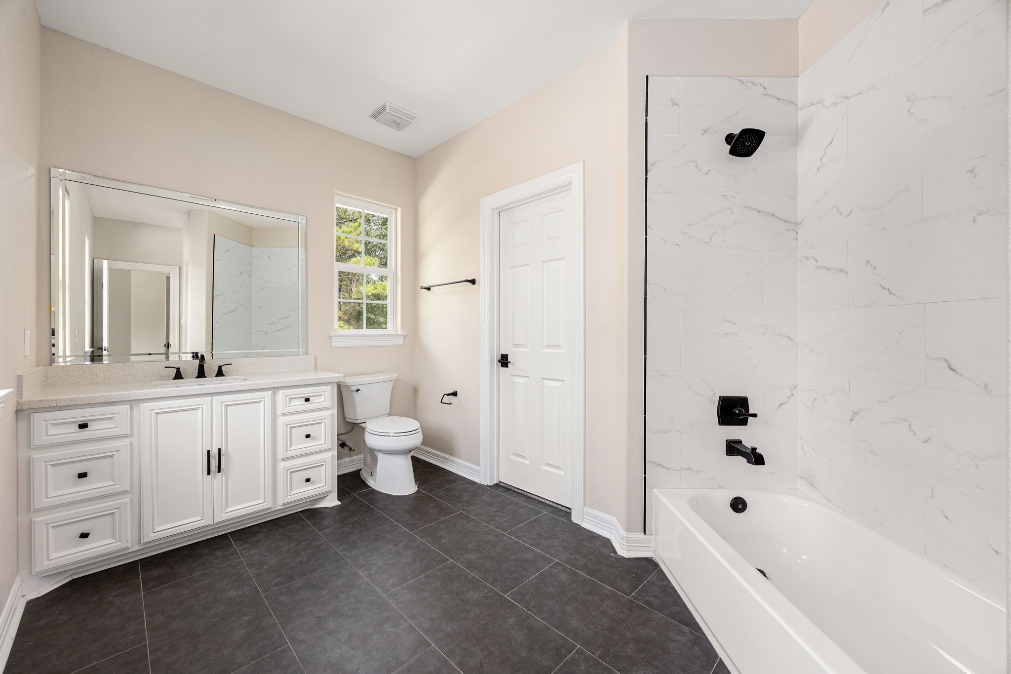 14882 Gingham Road Montgomery, TX 77356 - Photo 34 of 50 a bathroom with a double vanity sink a toilet a bathtub and shower