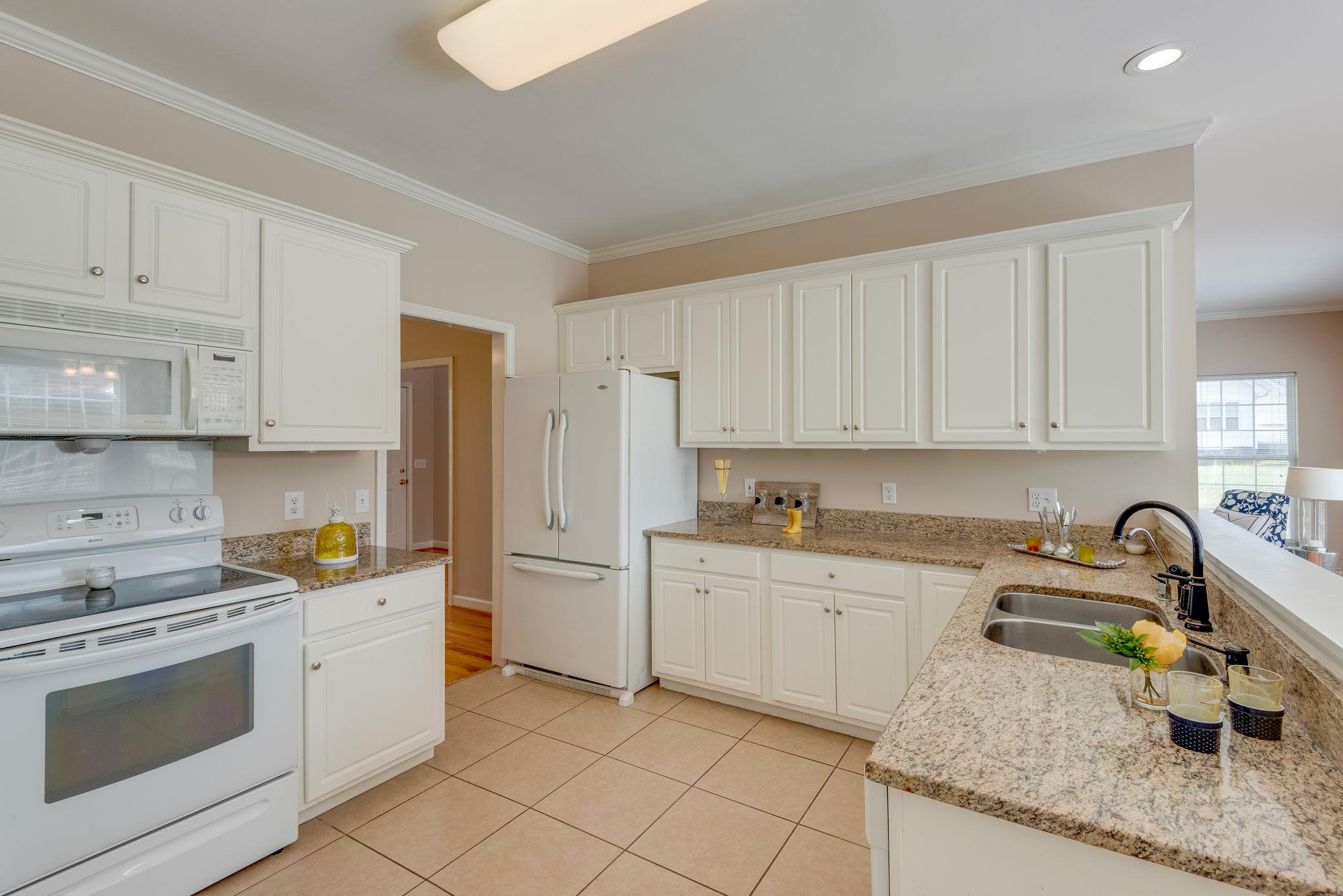 269 Eastside Road Burns, TN 37029 - Photo 15 of 22 a kitchen with granite countertop a sink stove and cabinets