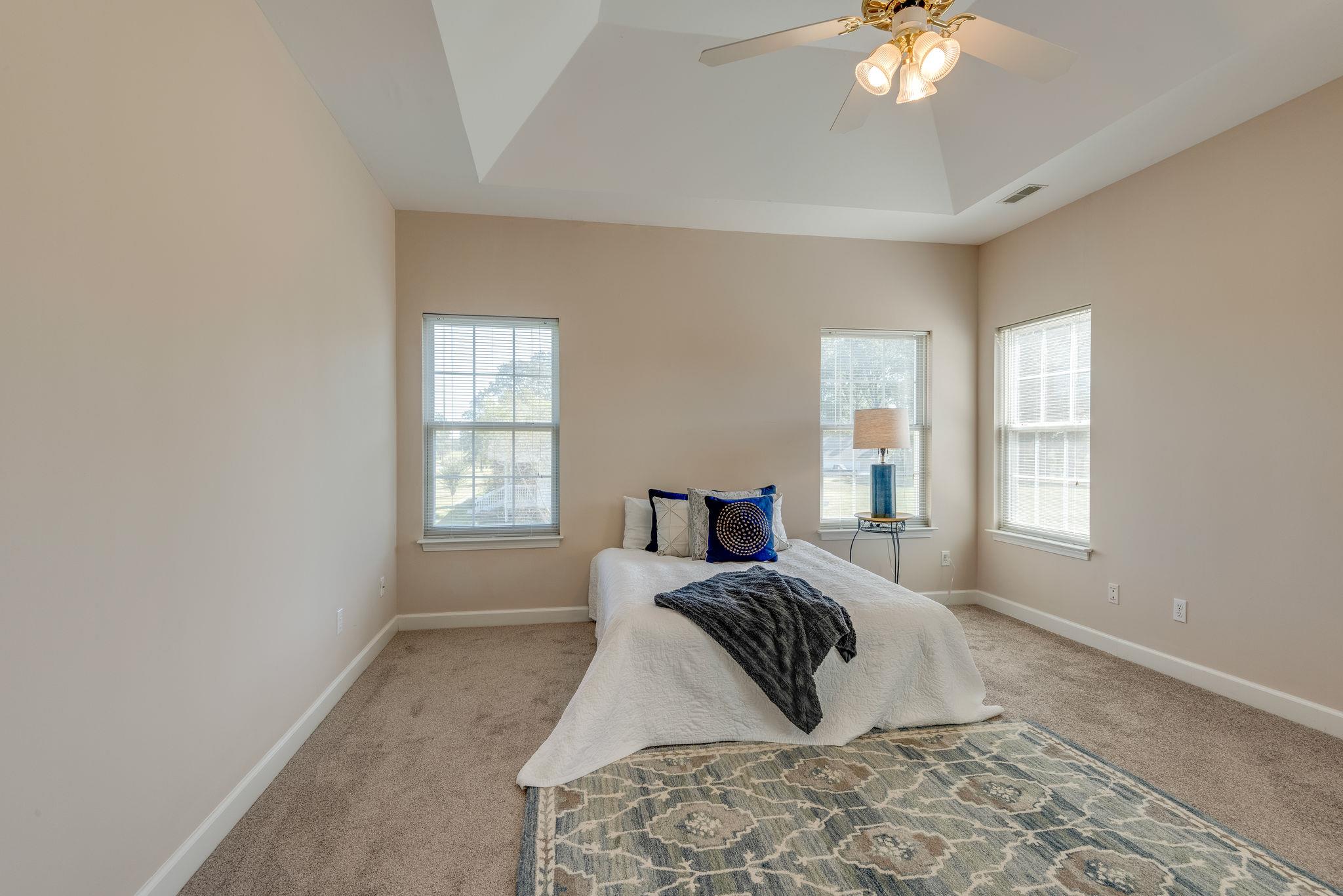 269 Eastside Road Burns, TN 37029 - Photo 18 of 22 a bed room with a bed and a chandelier