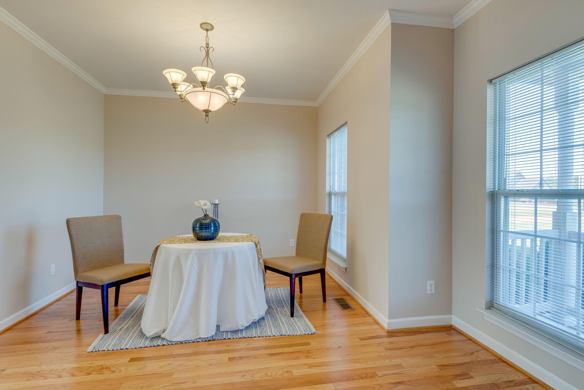 269 Eastside Road Burns, TN 37029 - Photo 8 of 22 a view of a dining room with furniture a chandelier and wooden floor