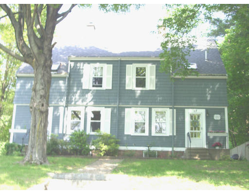 front view of a brick house with a yard