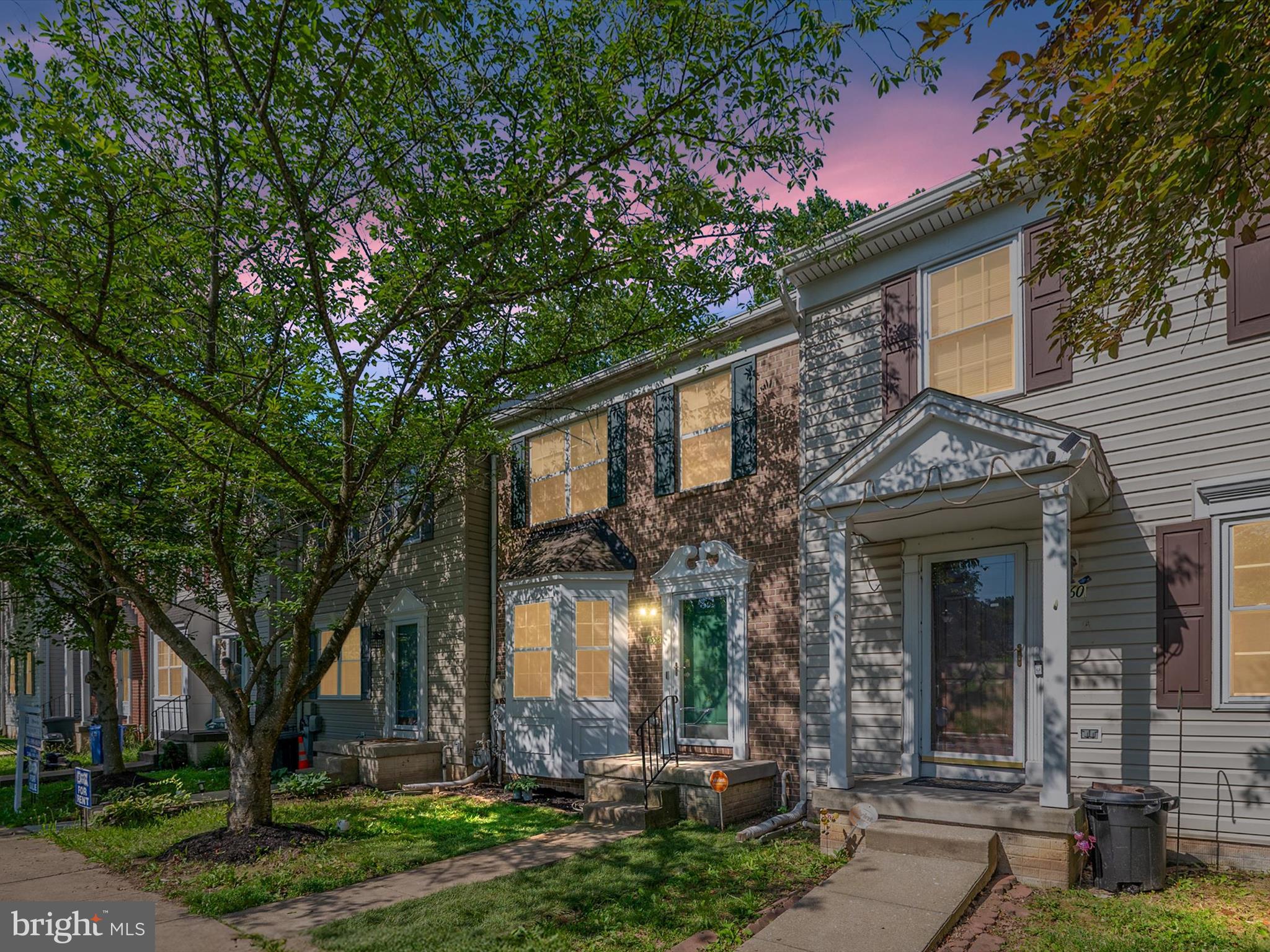 front view of a house with a tree