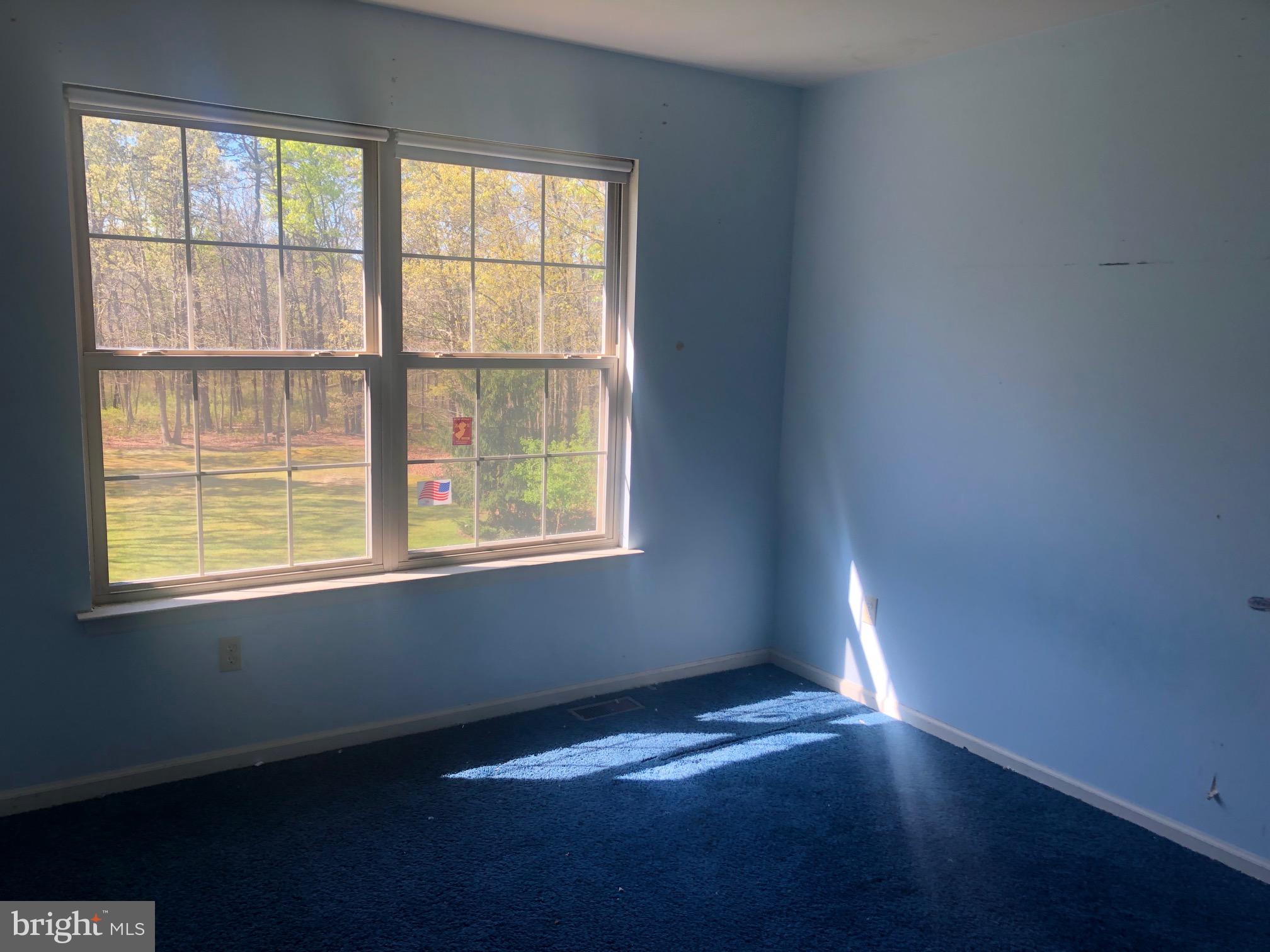 458 Weymouth Road Buena, NJ 08310 - Photo 10 of 12 a view of an empty room with wooden floor and a window