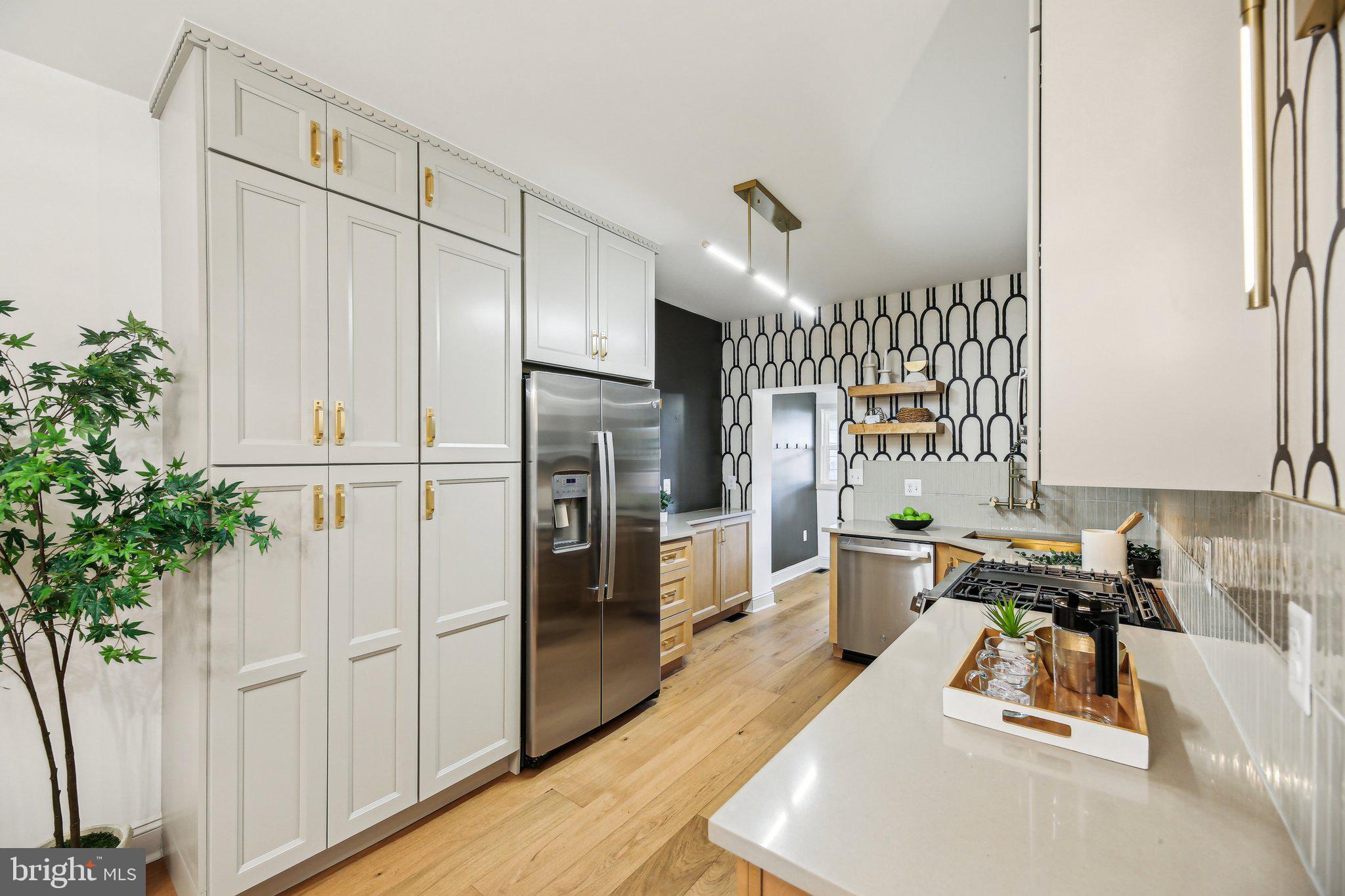 3348 Chestnut Avenue Baltimore, MD 21211 - Photo 13 of 39 a kitchen with white cabinets and stainless steel appliances