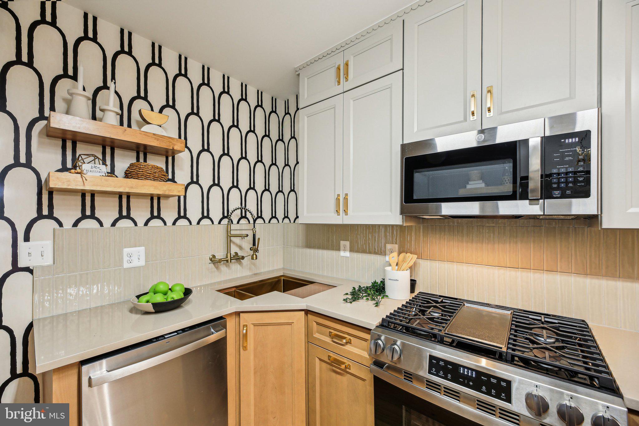 3348 Chestnut Avenue Baltimore, MD 21211 - Photo 15 of 39 a kitchen with stainless steel appliances a sink a stove and cabinets