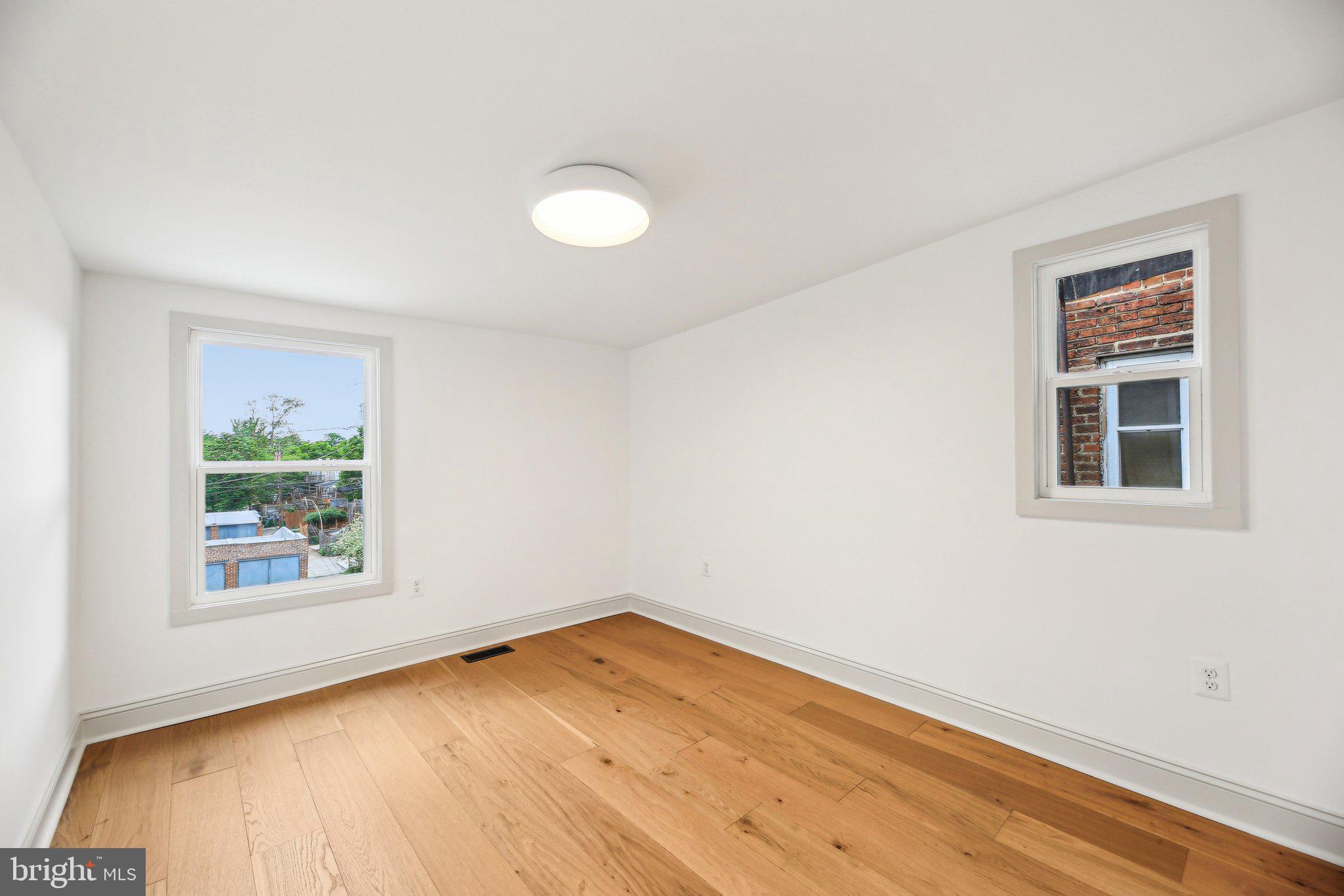 3348 Chestnut Avenue Baltimore, MD 21211 - Photo 21 of 39 a view of empty room with wooden floor and fan