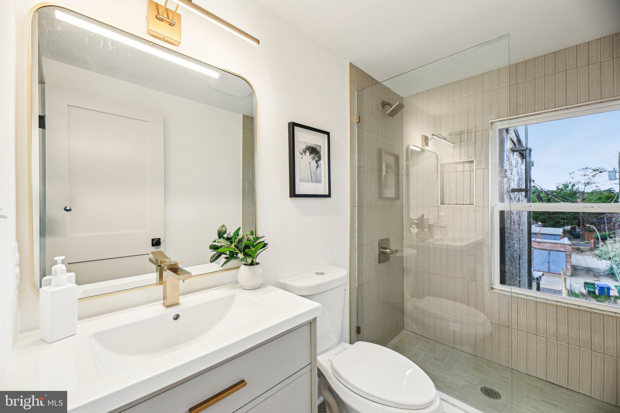 3348 Chestnut Avenue Baltimore, MD 21211 - Photo 22 of 39 a bathroom with a sink a toilet and shower