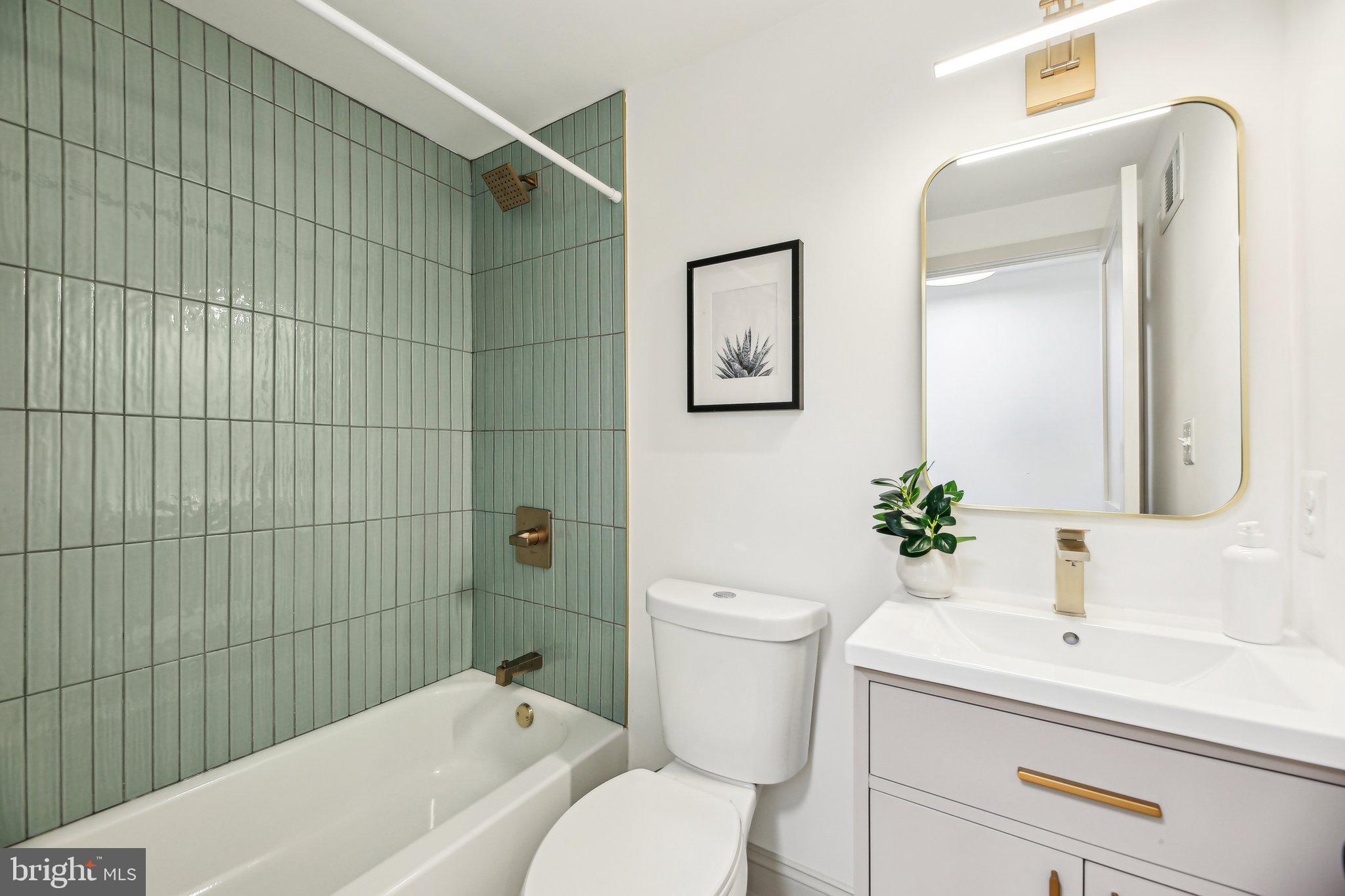 3348 Chestnut Avenue Baltimore, MD 21211 - Photo 26 of 39 a bathroom with a toilet a sink and mirror