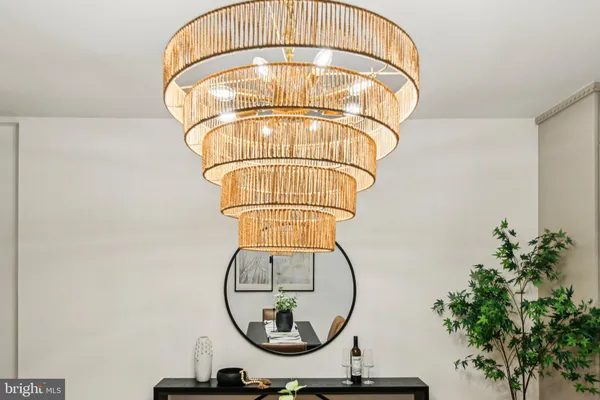 a dining room with furniture a chandelier and wooden floor