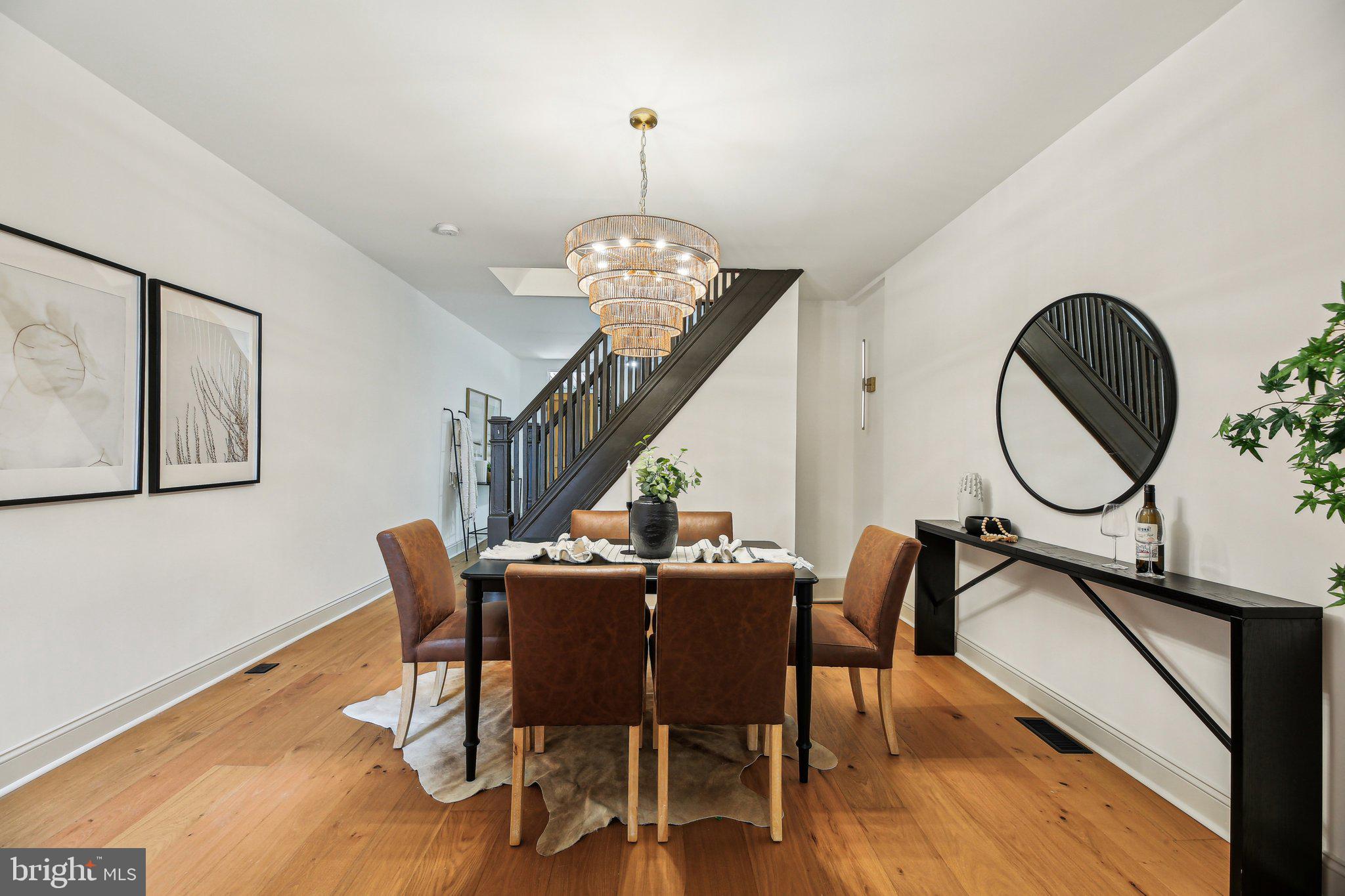 3348 Chestnut Avenue Baltimore, MD 21211 - Photo 10 of 39 a dining room with furniture a chandelier and wooden floor