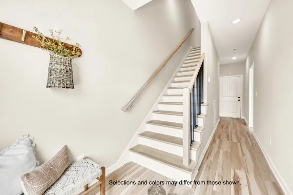 a view of a bedroom with wooden floor and stairs
