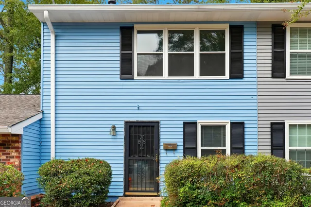 a view of a brick house with a large windows