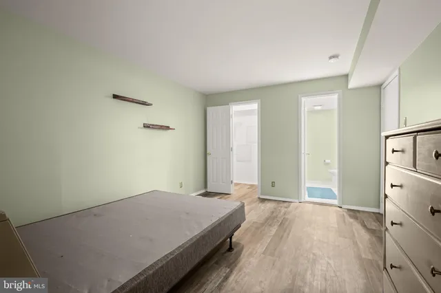 a bathroom with a granite countertop sink a large mirror and toilet