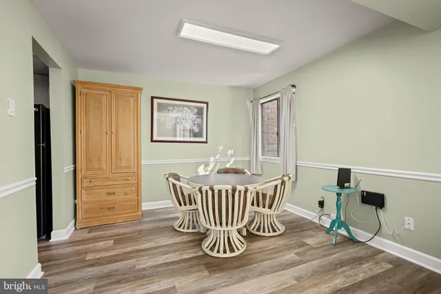 a kitchen with a stove a refrigerator and a table