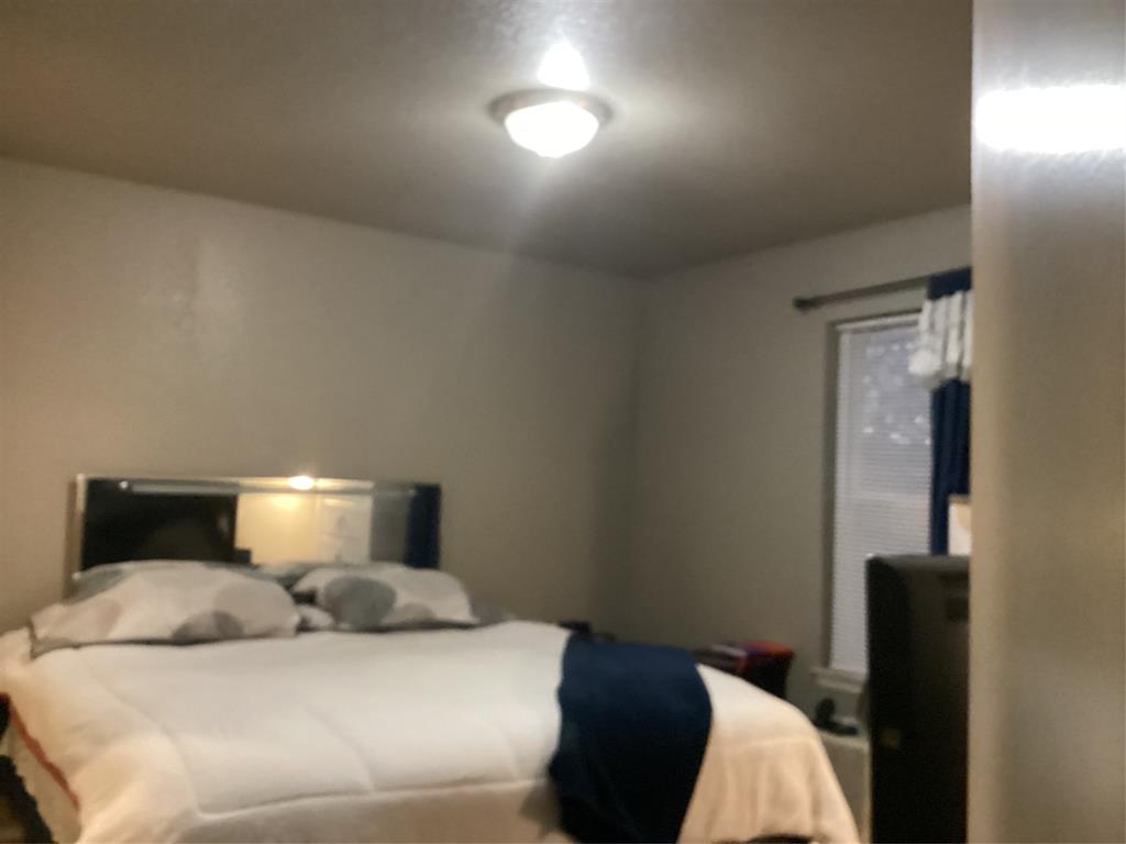 2003 Leath Street Dallas, TX 75212 - Photo 17 of 23 a bedroom with a bed and a lamp with window