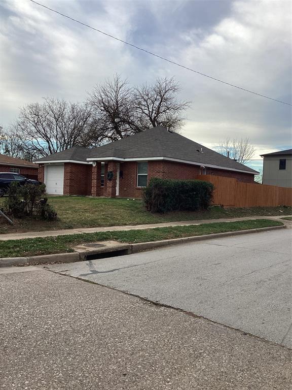 2003 Leath Street Dallas, TX 75212 - Photo 4 of 23 a front view of a house with a yard and garage
