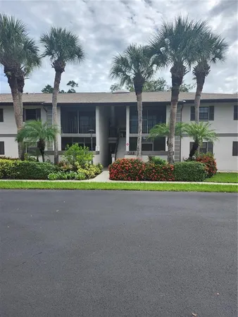 a front view of house with a garden