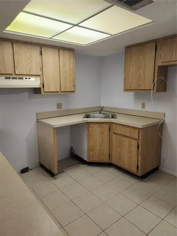 a kitchen with a sink a cabinets and window
