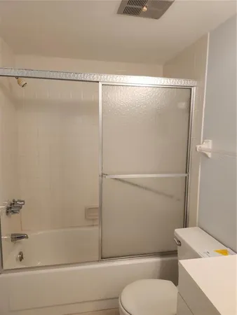 a bathroom with a shower and a toilet