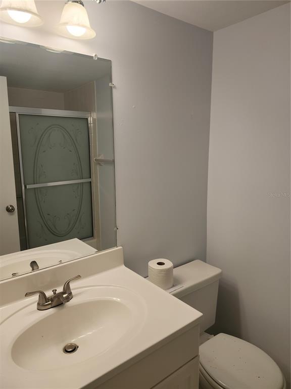 1515 Forrest Nelson Boulevard, Unit J104 Port Charlotte, FL 33952 - Photo 18 of 27 a bathroom with a sink a toilet and mirror
