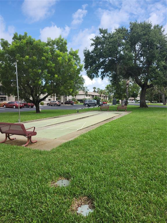 1515 Forrest Nelson Boulevard, Unit J104 Port Charlotte, FL 33952 - Photo 24 of 27 a view of a park with large trees