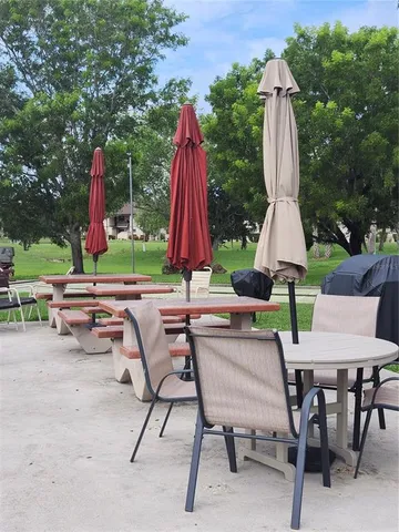 a view of backyard with table and chairs
