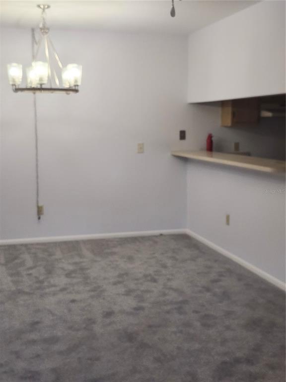 1515 Forrest Nelson Boulevard, Unit J104 Port Charlotte, FL 33952 - Photo 6 of 27 a kitchen with a sink cabinets and appliances