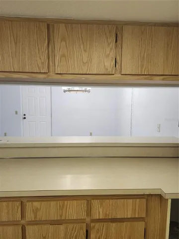 a view of kitchen cabinets and a wooden floor