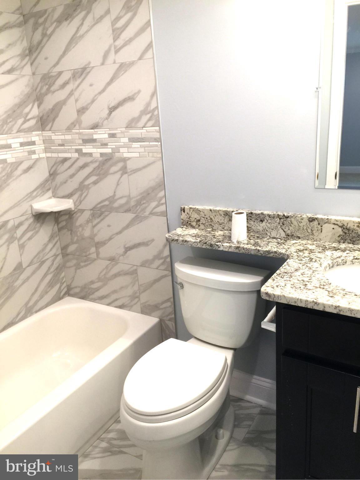 205 Biddle Road Accokeek, MD 20607 - Photo 11 of 24 a bathroom with a granite countertop toilet sink and mirror