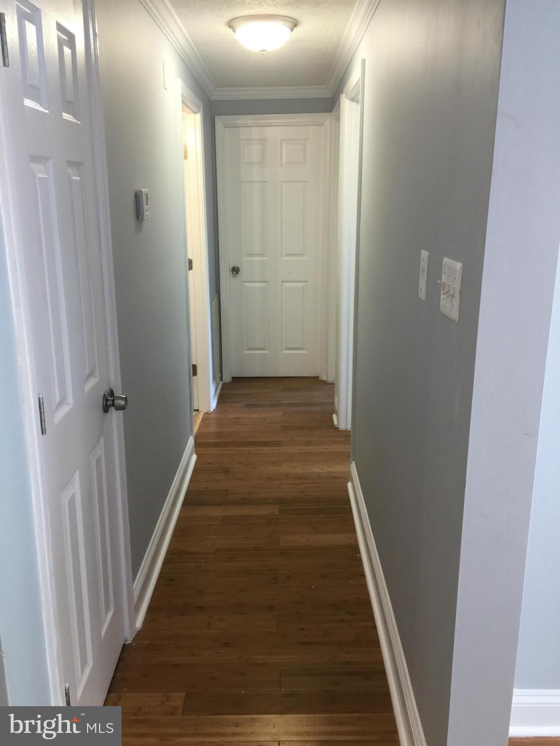 205 Biddle Road Accokeek, MD 20607 - Photo 18 of 24 a view of a hallway with wooden floor and staircase