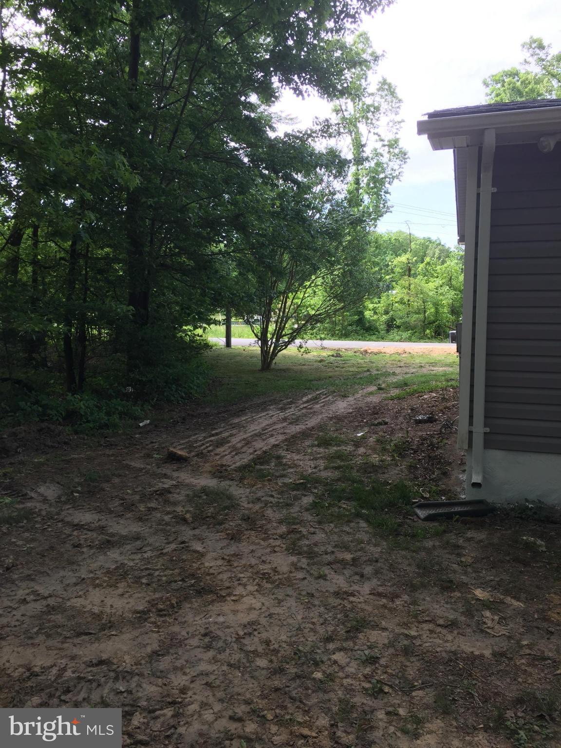 205 Biddle Road Accokeek, MD 20607 - Photo 22 of 24 a view of a yard with plants and large trees