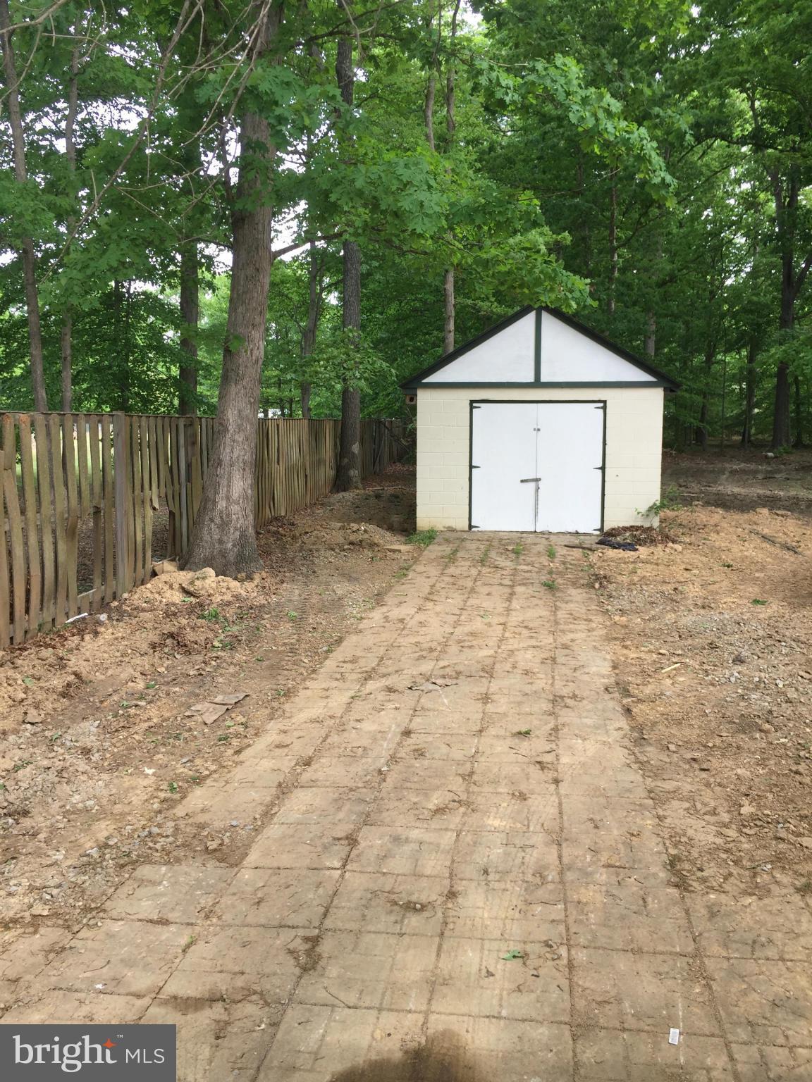 205 Biddle Road Accokeek, MD 20607 - Photo 24 of 24 a backyard of a house with a large tree and wooden fence