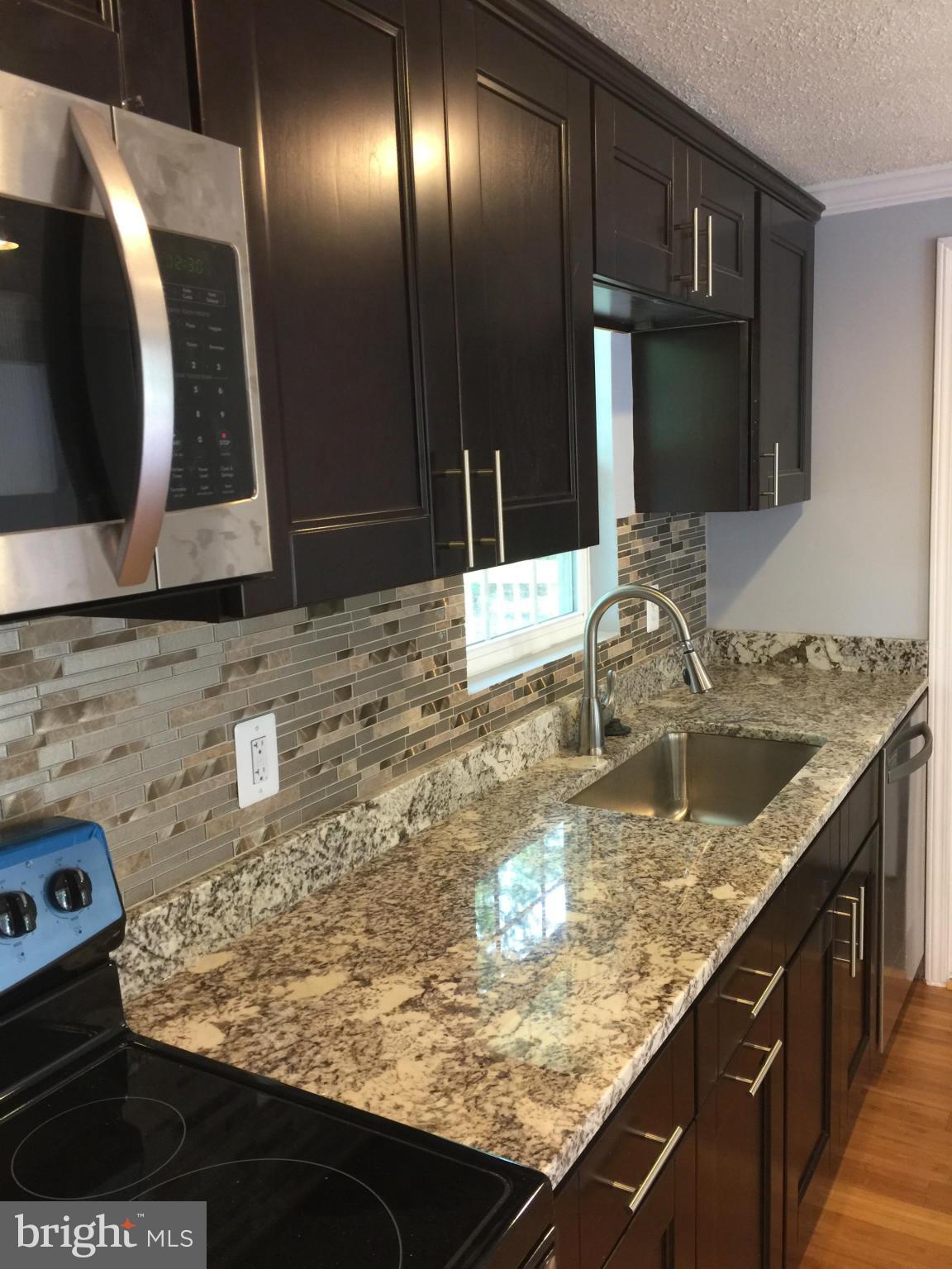 205 Biddle Road Accokeek, MD 20607 - Photo 4 of 24 a bathroom with a granite countertop sink and a mirror