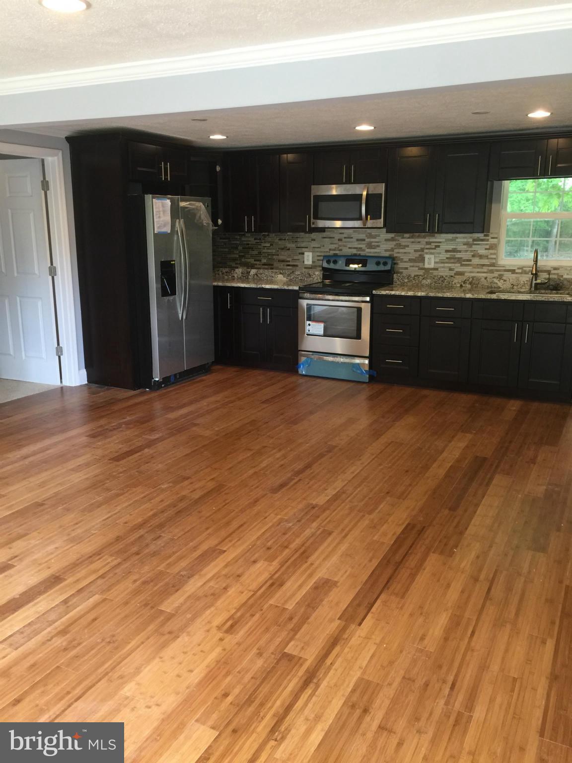 205 Biddle Road Accokeek, MD 20607 - Photo 6 of 24 a kitchen with stainless steel appliances granite countertop a sink and cabinets