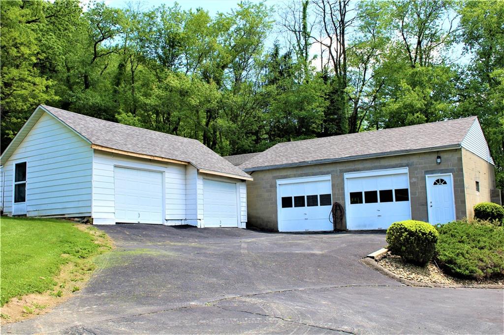 246 Oneida Valley Road Butler, PA 16001 - Photo 2 of 14 Two 2 large garages, one on right has a functioning car lift.