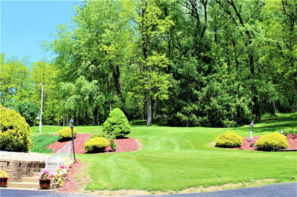 246 Oneida Valley Road Butler, PA 16001 - Photo 12 of 14 Professional landscaping throughout property with a glimpse into the 2.75 acre lot