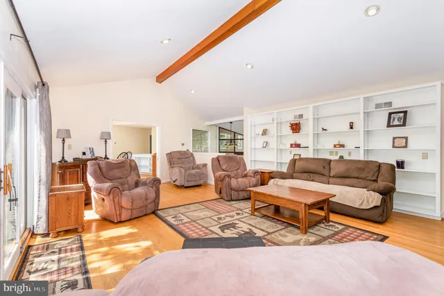 a living room with furniture rug and wooden floor