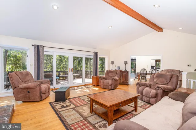 a living room with furniture and a floor to ceiling window