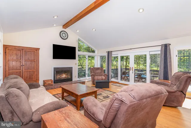 a living room with furniture fireplace and flat screen tv