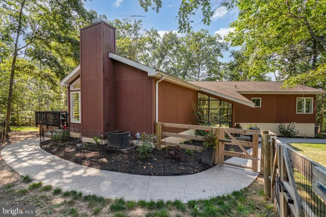 a view of backyard with outdoor seating and plants