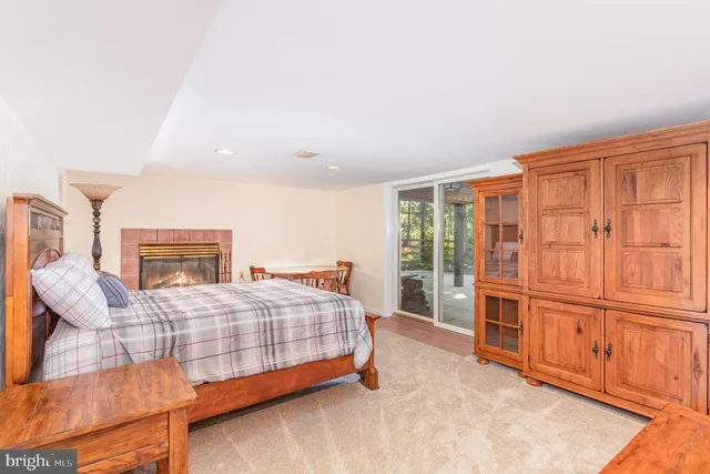 a bedroom with a bed dresser and a large window