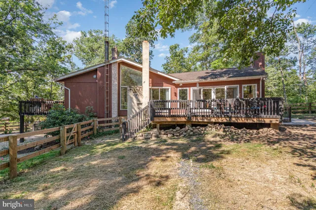 a backyard of a house with yard and outdoor seating