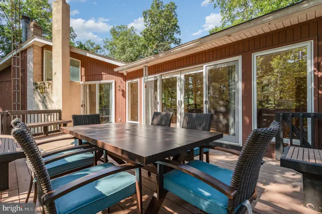 a view of a patio with a table chairs and a backyard