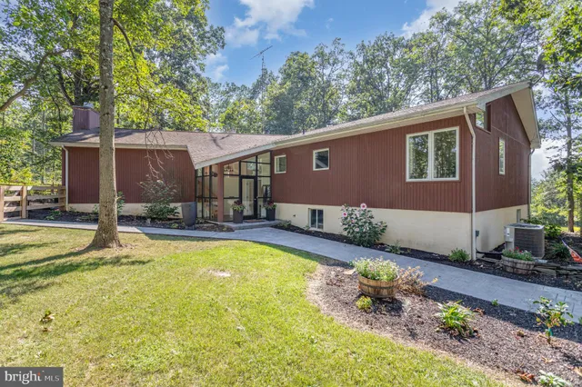 a view of a house with pool and chairs