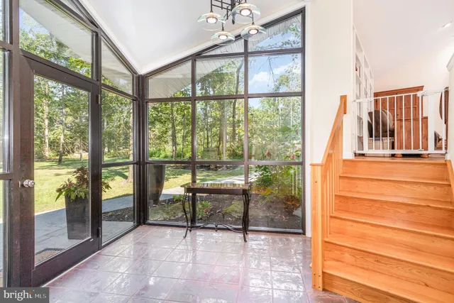 a view of a room with wooden floor and windows