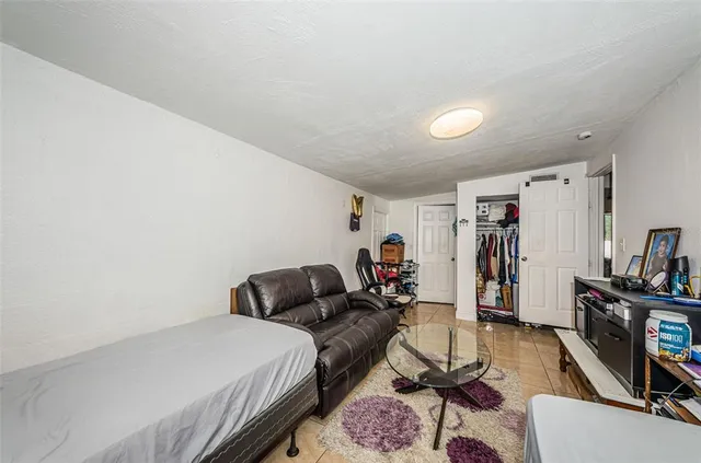 a bedroom with furniture and a wooden floor