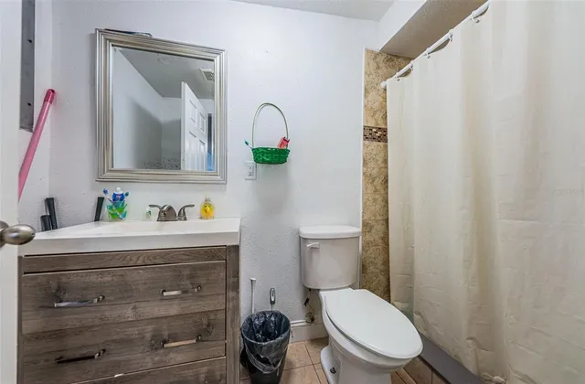 a bathroom with a toilet a sink and a mirror