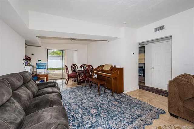 a living room with furniture a rug and a table