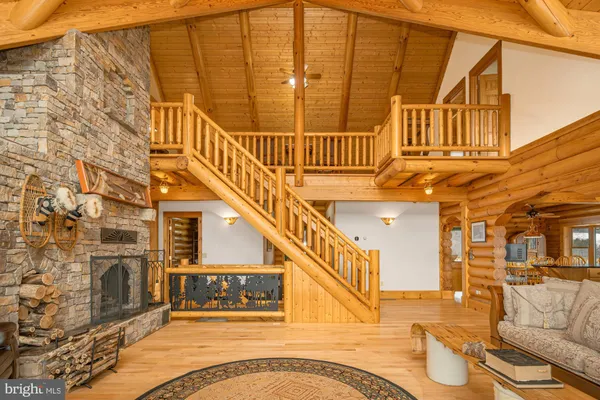 a dining room with stainless steel appliances a couch and next to a dining table with wooden floor